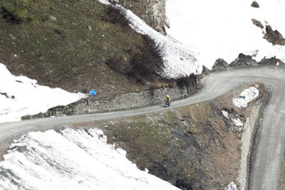 High angle view of road by snow covered mountain