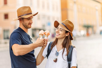 Happy couple eating ice cream in rome, italy. beautiful bright ice cream  in the hands