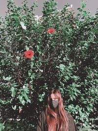 Woman standing by flowering tree