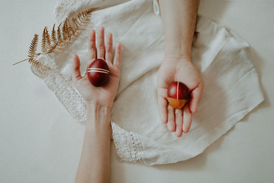 High angle view of woman hand on bed