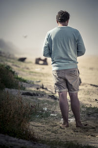 Rear view of woman standing on field