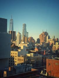Buildings in city against clear sky