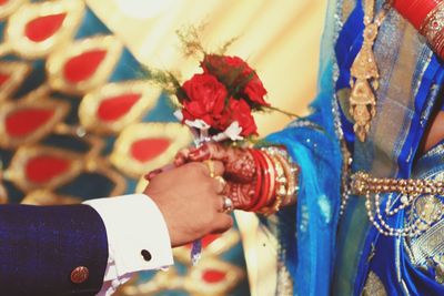 Close-up of hands holding flowers