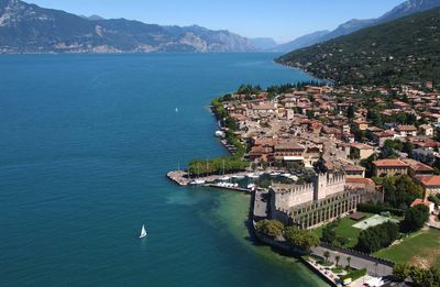 High angle view of townscape castle by lake garda 
