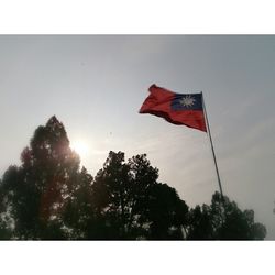 Low angle view of american flag against sky