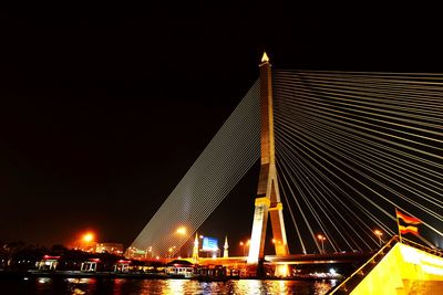 Low angle view of suspension bridge at night