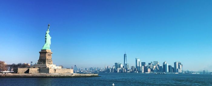 Statue of liberty by hudson river in city