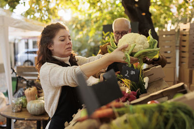 Side view of woman holding food