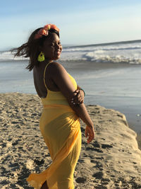 Young woman standing at beach