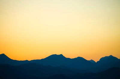 Scenic view of mountains against sky during sunset