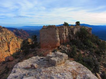 Rock formations on landscape against sky