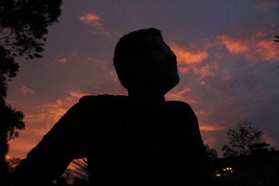 Low angle view of silhouette man against sky during sunset