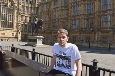 Portrait of man standing in city