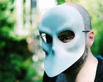 Close-up of man in mask outdoors