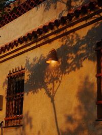 Low angle view of lantern on old building