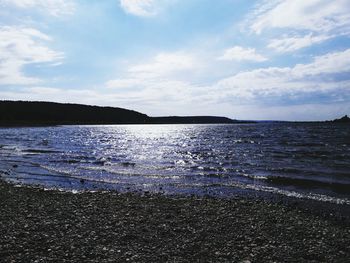 Scenic view of sea against cloudy sky