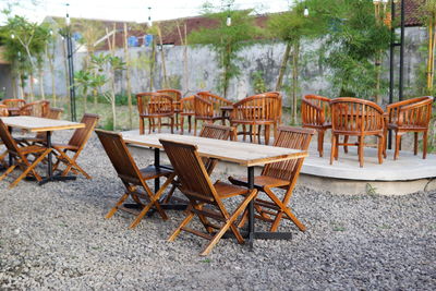 Empty chairs and tables in yard