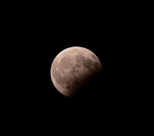 Low angle view of moon against clear sky at night