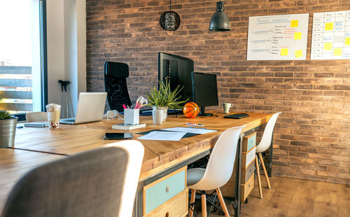 Table and chairs against wall
