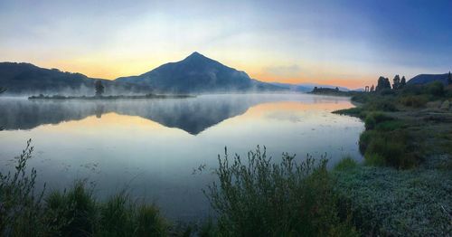 Scenic view of lake against sky during sunset