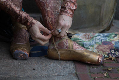 Low section of ballet dancer wearing shoe