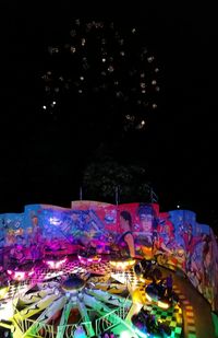 Illuminated ferris wheel at night