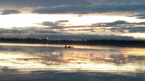 Scenic view of lake against cloudy sky