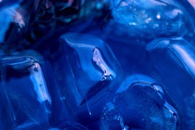 Close-up of ice cubes in blue soda