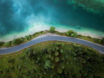 Scenic view of road amidst trees against sky