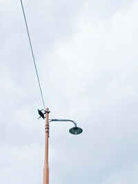 Low angle view of street light against sky