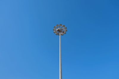 Low angle view of floodlight against clear blue sky