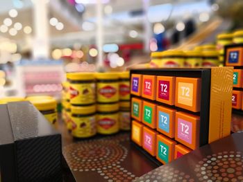 Close-up of multi colored boxes and bottles in supermarket for sale