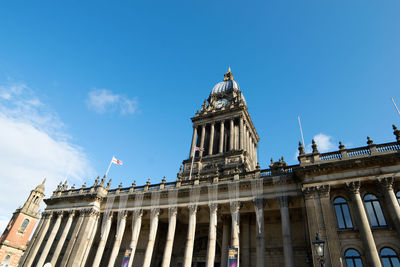 Low angle view of historic building against blue sky