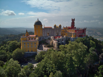 High angle view of trees and buildings against sky, castle
