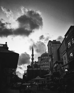 Low angle view of buildings against cloudy sky