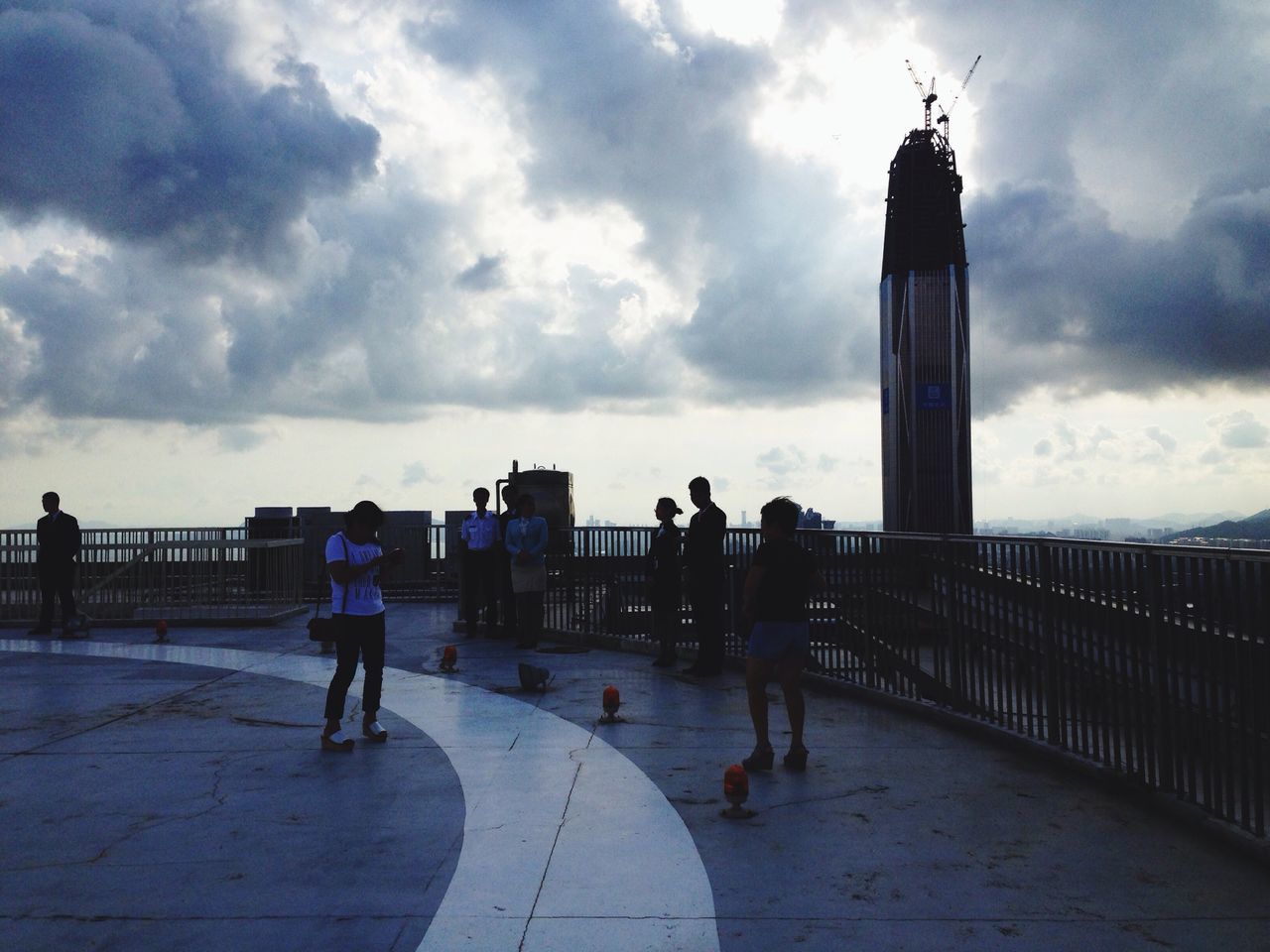 sky, men, walking, built structure, cloud - sky, architecture, lifestyles, full length, building exterior, person, leisure activity, cloudy, cloud, rear view, the way forward, city, city life, street