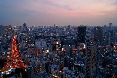 High angle view of illuminated city buildings against sky