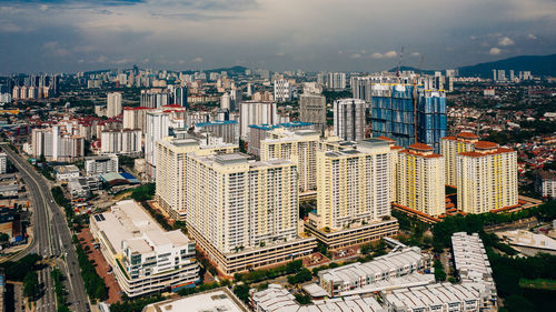 High angle view of modern buildings in city against sky