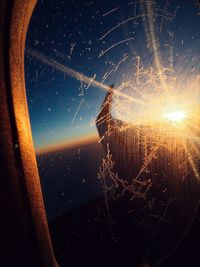 Close-up of airplane window against sky