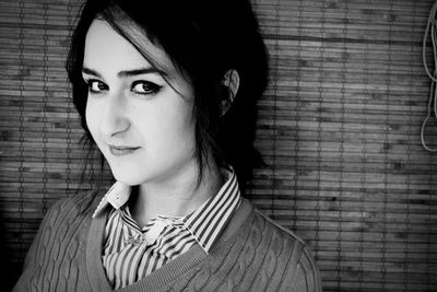 Portrait of woman against wall