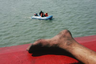 Close-up of man sitting on boat in sea