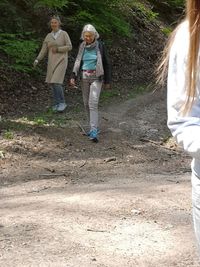 Full length of woman walking on dirt road