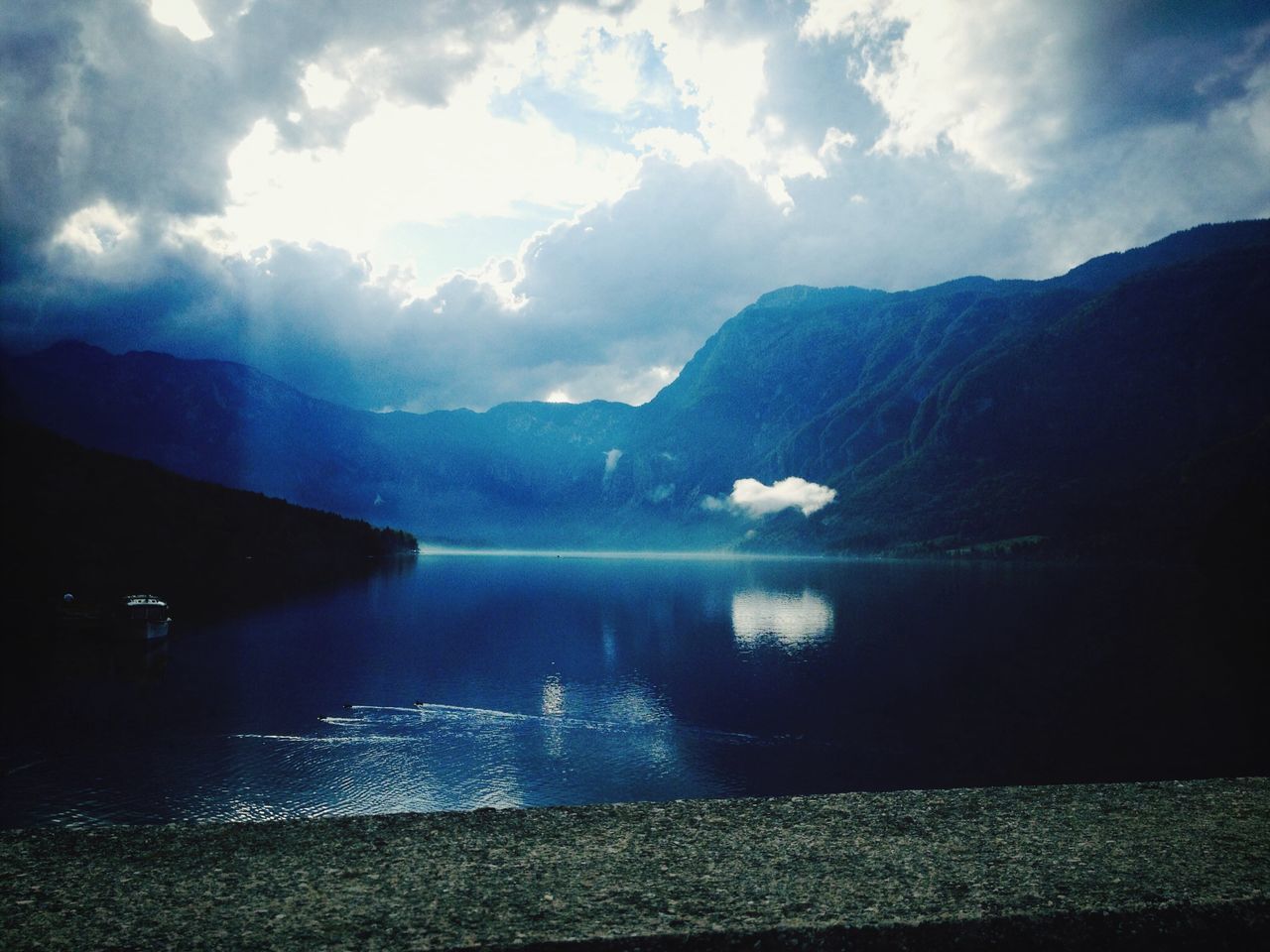 sky, cloud - sky, mountain, silhouette, sunlight, nature, beauty in nature, tranquility, scenics, lifestyles, cloud, men, unrecognizable person, tranquil scene, leisure activity, sunbeam, outdoors, blue