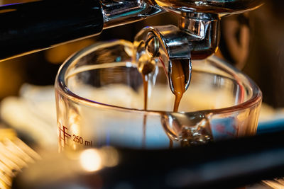 Close-up of coffee pouring in glass