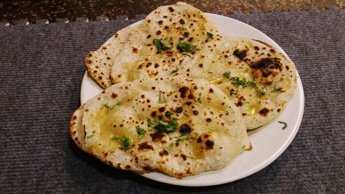 High angle view of butter naan served in plate on table