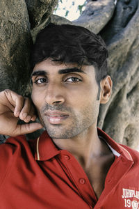 Close-up portrait of young man against tree