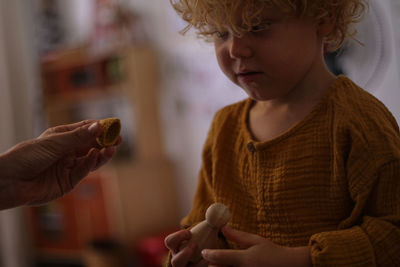 Cute boy holding chocolate at home