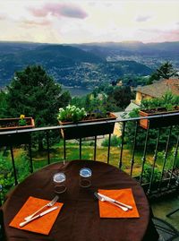 High angle view of drink on table in balcony against sky