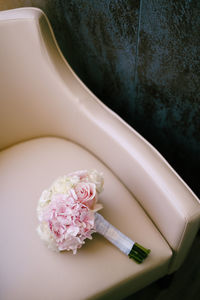 High angle view of hand holding flower