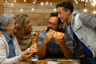 Smiling family eating food on table